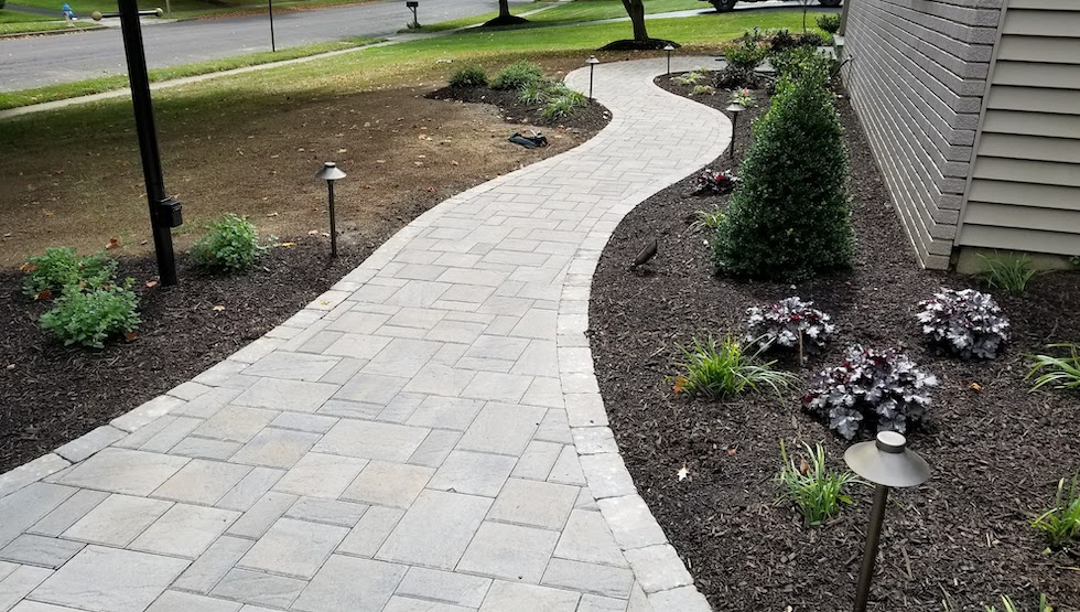 Pathway lined with landscaping and lighting