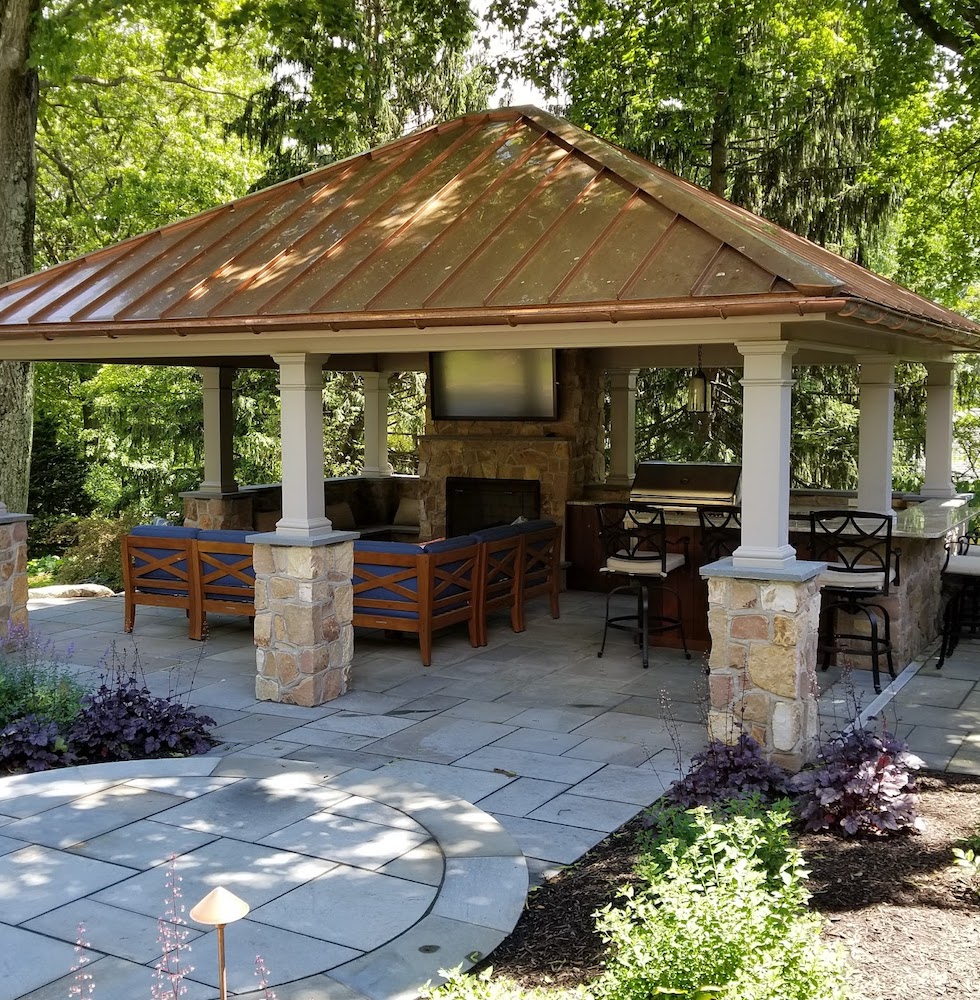 Copper roofed pavilion with lounge area, media center, and outdoor kitchen