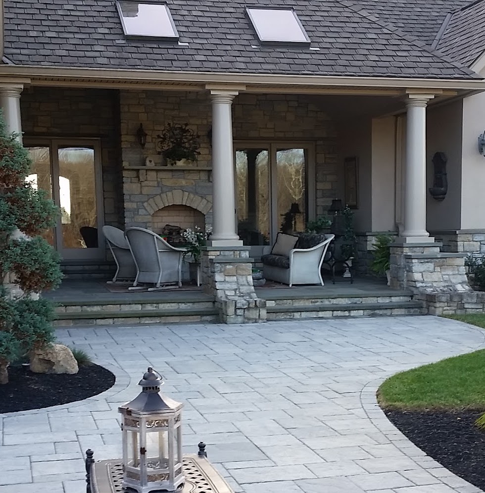 Covered porch with columns and stone fireplace