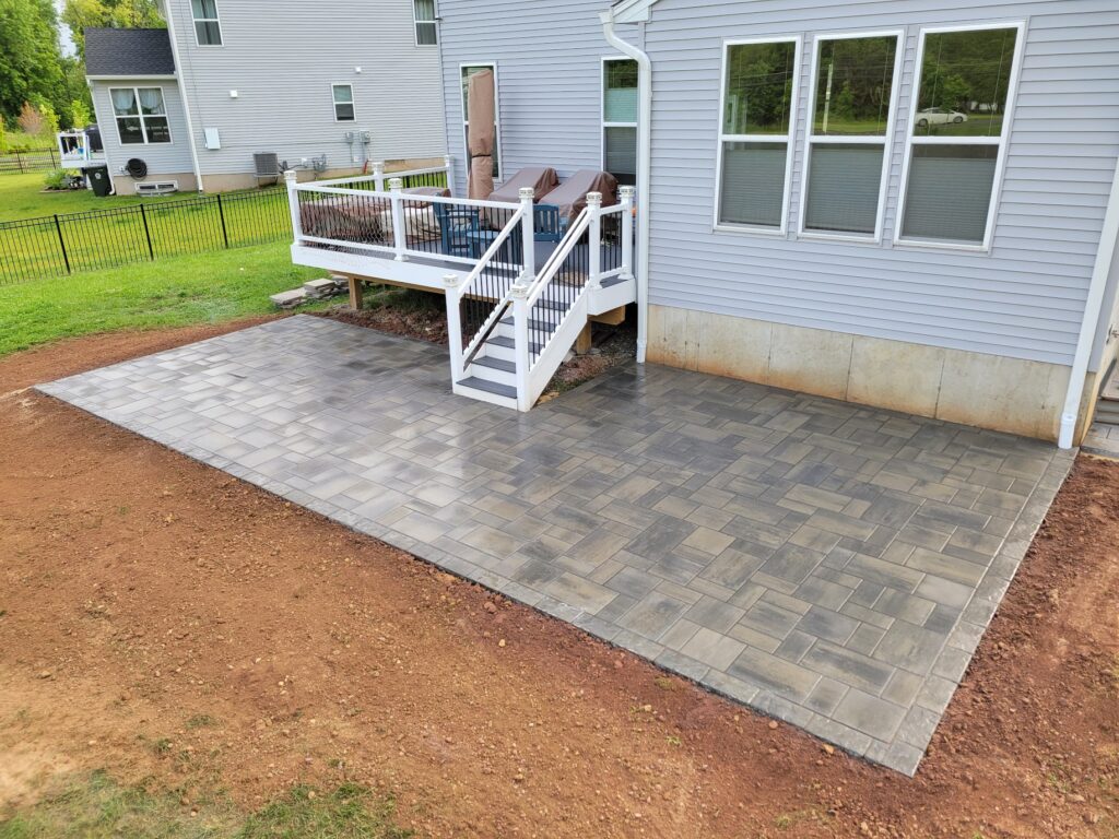 Custom deck with steps leading to long rectangle patio