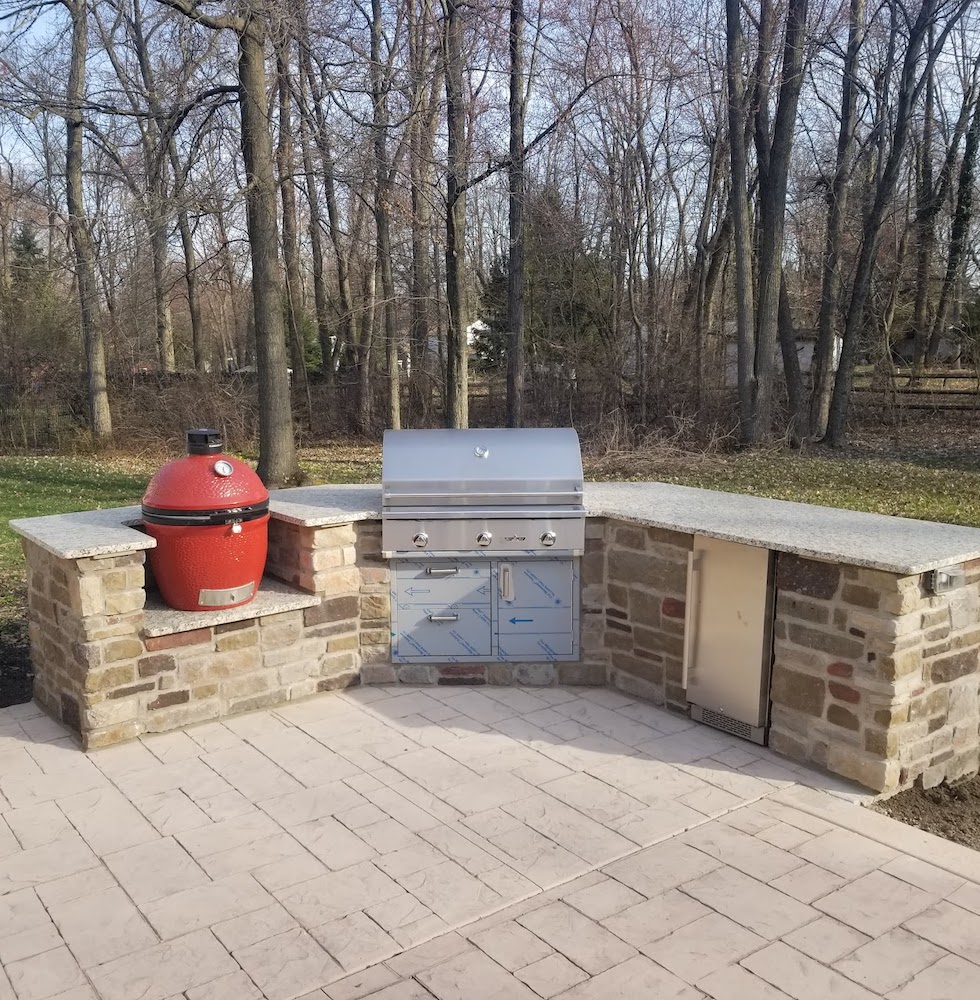 Outdoor grill area with red egg smoker
