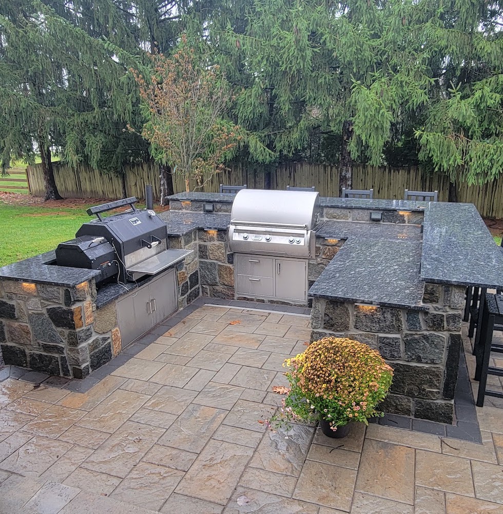 Outdoor kitchen with grill and black counter tops