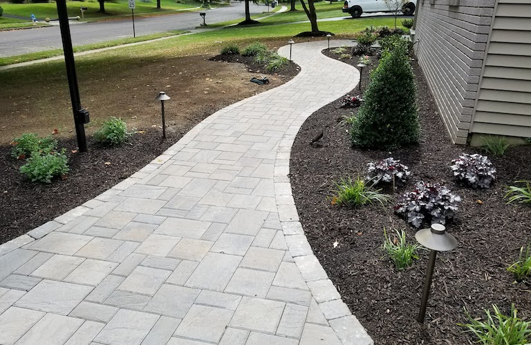 Hardscape walkway curving around landscaping