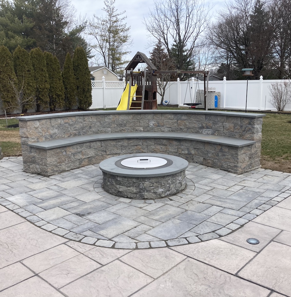 stone fire pit with decorative stone walls as seating