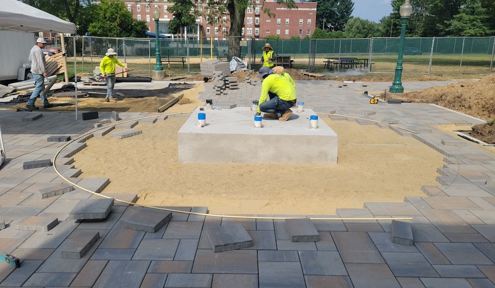 Workers installing custom paver design