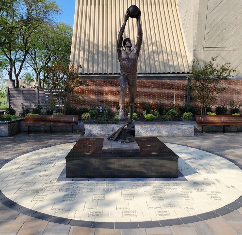 Statue holding a ball standing within a circle of custom pavers